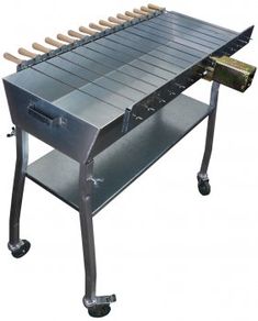 an outdoor bbq grill on wheels with wooden handles and trays attached to it