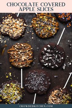 chocolate covered apple slices with nuts and sprinkles on sticks in front of them