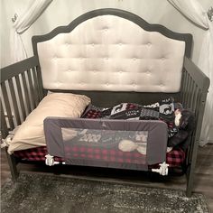 a toddler bed with a baby crib next to it