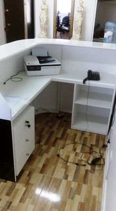 an office desk with a printer on it