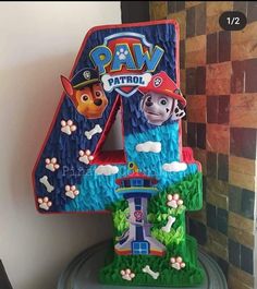 a cake shaped like the number four for paw patrol