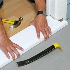 a man is working with tools on the floor next to a piece of plywood