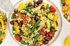 three bowls filled with different types of pasta and veggies next to each other