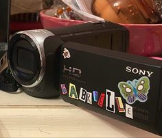 a camera sitting on top of a table next to a laptop