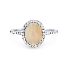 a ring with an oval shaped stone surrounded by small white diamonds on the sides, set in