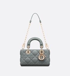 The Lady D-Joy micro bag captures the House's vision of elegance and beauty by showcasing the iconic streamlined aesthetic of the Lady Dior line. Sleek and refined, the timeless creation is crafted in cloud blue lambskin with Cannage topstitching and enhanced by a pale gold-finish metal D.I.O.R. charm. Featuring one removable chain strap and another adjustable and removable leather strap, the Lady D-Joy bag can be carried by hand, worn over the shoulder or crossbody as an ideal day or evening co Lady Dior D Joy, Lady D Joy Bag, Lady D, Dream Bag, Dior And I, Micro Bag, Dior Book Tote, Dior Couture, Luxury Bag