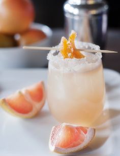 grapefruit cocktail with orange garnish on white plate