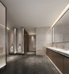 an empty bathroom with urinals and sinks in the middle, surrounded by mirrors