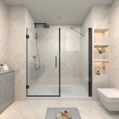 a bathroom with a toilet, sink and shower stall in white marbled finish to the walls