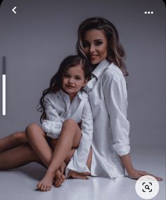 a woman and child are posing for a photo in white shirts, pants and heels