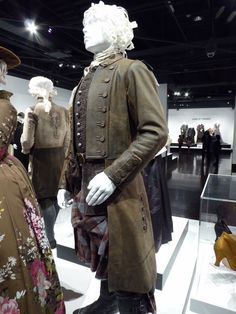 two mannequins dressed in period clothing on display