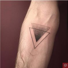 a small triangle tattoo on the arm