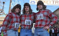 three young men in plaid shirts posing for a photo at the turkey trot event