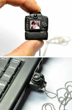 a hand holding a small camera over a laptop computer and another photo being taken on the keyboard