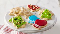 a white plate topped with lots of decorated cookies