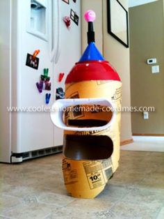 an upside down bottle sitting on the floor in front of a refrigerator with magnets attached to it