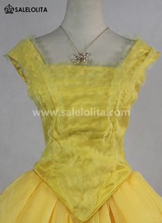 a yellow dress with ruffles on the skirt