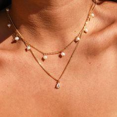 Our Aliyah necklace is simple yet elegant! This piece was crafted from high-quality gold filled material, making it the perfect choice for a wedding, as well as for day-to-day wear. The necklace includes a delicate Cubic Zirconia teardrop, suspended from a Cuban curb chain. An ideal choice for any bridal look, or for adding a touch of sophistication to your everyday jewelry. • Single necklace with charm• Gold Filled• Chain Length: 18" + 1" extender• Charm size: 14mm x 5mm 14k Gold-filled Teardrop Pearl Pendant Necklace, 14k Gold Filled Pearl Drop Teardrop Necklace, Teardrop Pearl Pendant Necklace In 14k Gold Filled, 14k Gold-filled Teardrop Necklace With Pearl Charm, 14k Gold Filled Teardrop Necklace With Pearl Charm, Teardrop Pearl Charm Necklace In 14k Gold Filled, Dainty Teardrop Pearl Chain Drop Necklace, White 14k Gold Filled Teardrop Necklace, Gold Teardrop Pearl Charm Necklaces