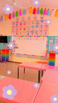 an empty classroom with pink tables and colorful decorations