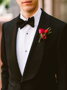 a man in a tuxedo with a flower on his lapel