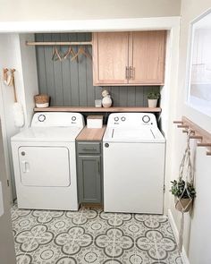 a washer and dryer sitting in a laundry room next to each other on the floor