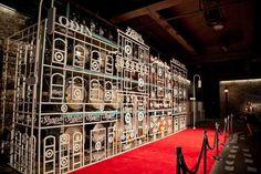 a red carpeted area with several metal shelvings on it