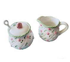 two ceramic teapots with pink roses on them