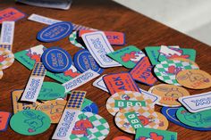 many different colored stickers on a wooden table