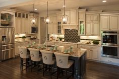 a kitchen filled with lots of white cabinets and counter top space next to an oven