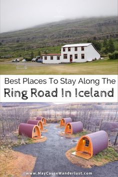 the road in iceland is lined with orange barrels and there are two houses on each side