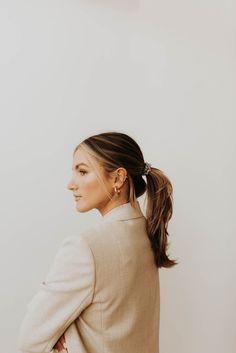 a woman with her hair in a ponytail