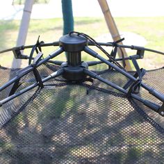 an upside down view of the top of a netted umbrella with metal poles and handles