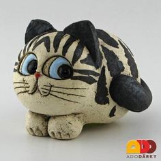 a ceramic cat with blue eyes and black stripes