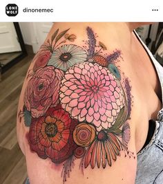 a woman's shoulder with flowers on it