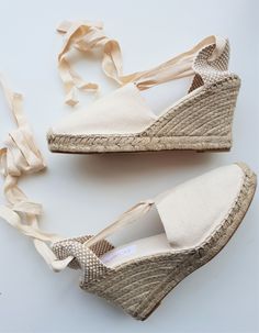 "Lace-up espadrille wedges in IVORY canvas, 9cm heels (3.54 inches). Laces in the same ivory canvas, can be tied up close to the knees, or wrapped around the ankles. The ribbon ends come glued to prevent fraying. The canvas is hand-sewn with visible seam, following traditional techniques. Reinforced in the front with extra stitching. Padded insole. The rope soles are anti-slippery, made of threaded jute fiber and covered with rubber. The fiber braids have been handwoven by Spanish artisans accor Lace Up Espadrille Wedges, Heel Wedges, Ribbon Ends, Lace Up Espadrilles, High Heel Wedges, Vegan Shoes, Espadrille Shoes, Wedge Espadrille, Espadrilles Wedges