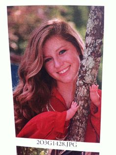 an old photo of a woman leaning on a tree