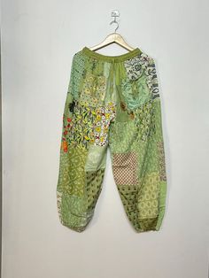 a pair of green pants hanging on a wall