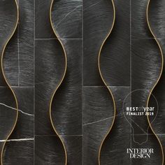 an artistic wall design with wavy lines and curves in black marbled tile, as well as gold trimmings