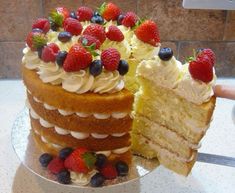 a cake with white frosting and strawberries on top