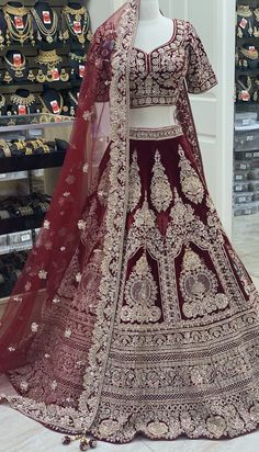 a red and white bridal gown on display in a store