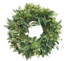 a green wreath with leaves and flowers on it