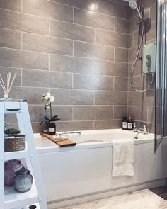 a white bath tub sitting next to a walk in shower