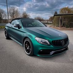 a green sports car parked in a parking lot