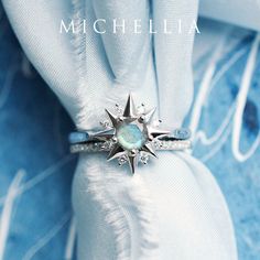 a close up of a ring on top of a white cloth with a star design