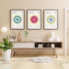 three framed art prints on the wall above a coffee table with a potted plant