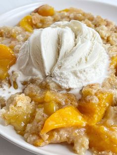 a close up of a plate of food with fruit and ice cream on it's top