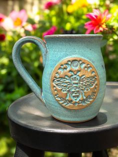 a blue mug sitting on top of a black table