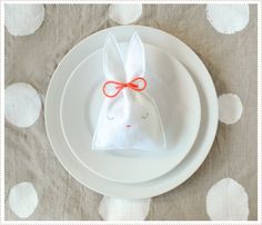 a white plate topped with a bunny napkin