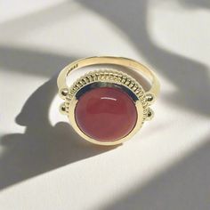 This stately ring is quintessentially classic in design, and is based on several Roman examples dating to the first and second centuries AD found in Bay of Naples towns, and in areas that were at one point known as Roman Britain. Its focal point is a prominent round stone in a bezel setting, which is crowned by a brilliant ribbed border. "Dignitas" was an important and serious concept in the Roman world - and something to which all Romans aspired - though it is difficult to define today. It mean Bay Of Naples, Roman Britain, Large Stone Rings, Red Carnelian, Jewelry Catalog, Aqua Chalcedony, Inspired Jewelry, Red Garnet, The Prestige