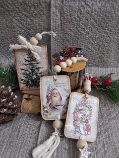 some ornaments are sitting on a blanket near pine cones and other decorations, including an ornament